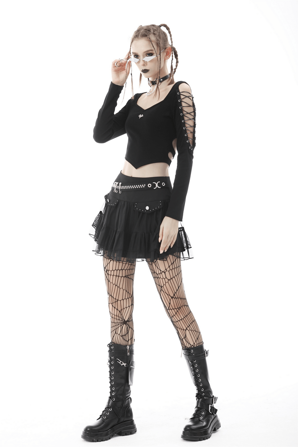 Punk rock batwing crop top with lace-up details, layered with a mini skirt and fishnet tights, perfect for edgy style.