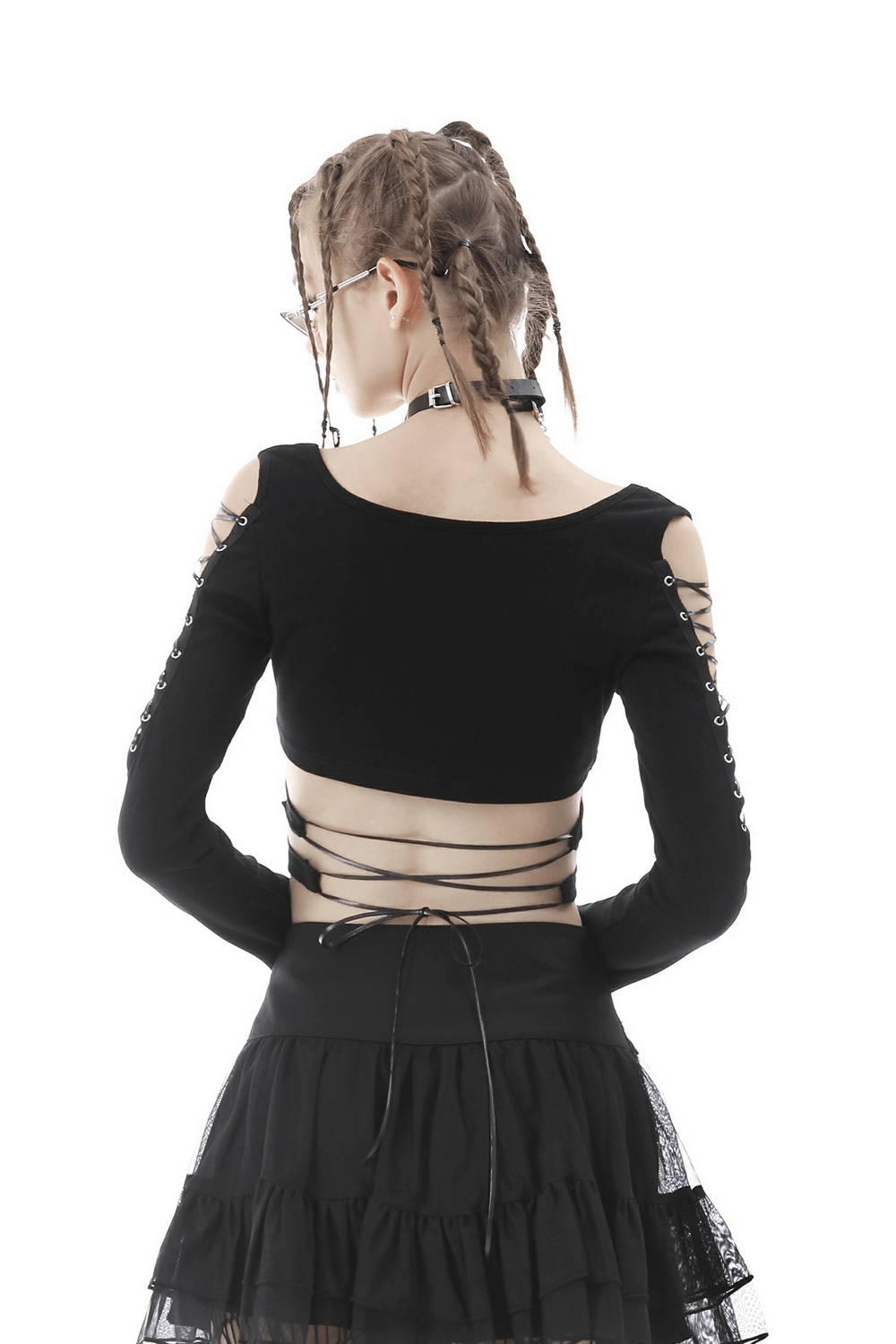 Back view of a punk rock batwing crop top with lace-up details, paired with a black tulle skirt.