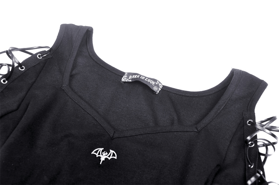 Close-up of a black Punk Rock Batwing Crop Top with lace-up sleeves and bat logo detailing.