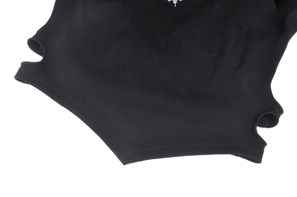 Close-up of the edgy batwing crop top showcasing the unique lace-up design and soft black knit fabric.