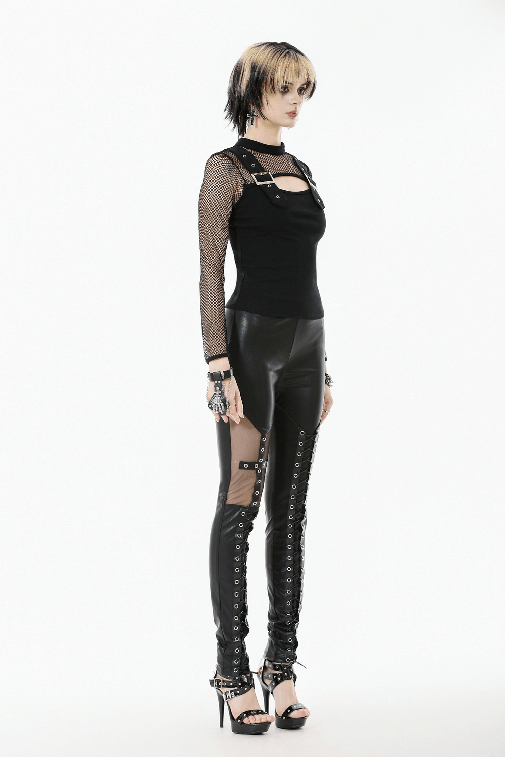 Punk Rock Black Fishnet Sleeved Top with Cutout and Straps paired with edgy black leather pants and strappy heels.