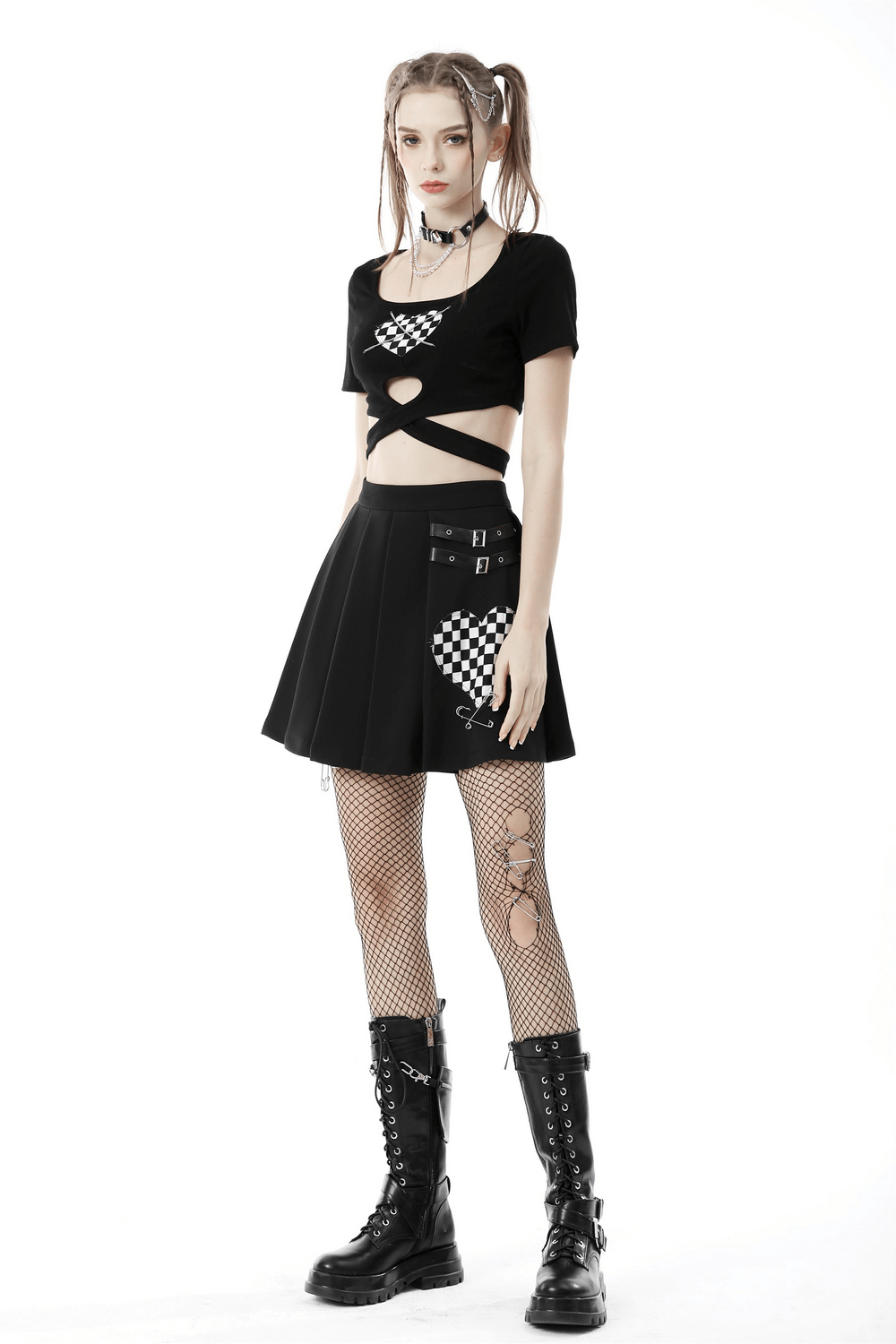 Punk rock model in a black heart checkered crop top with cross waist and stylish black skirt, showcasing edgy fashion vibes.