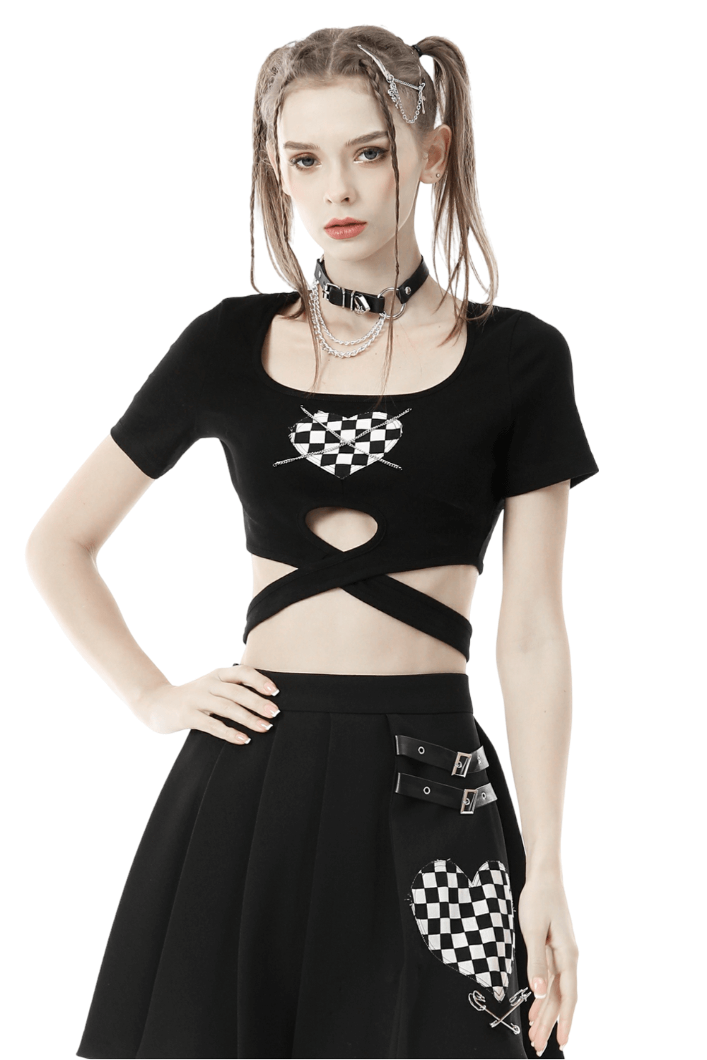 Punk rock black heart checkered crop top with cross waist detail, styled with an edgy black skirt.