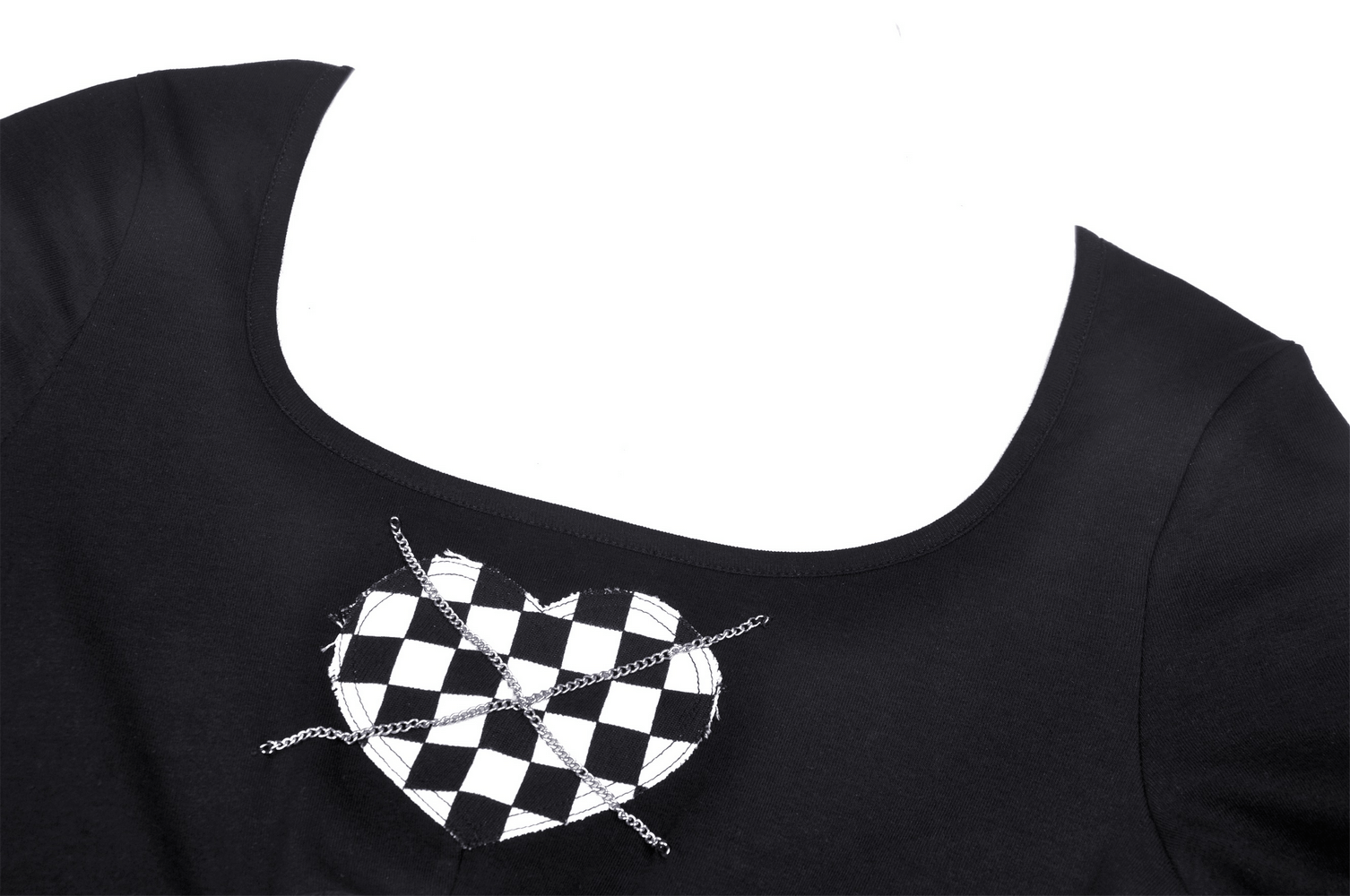 Close-up of a black crop top featuring a checkered heart design and chain detail, perfect for punk rock styles.