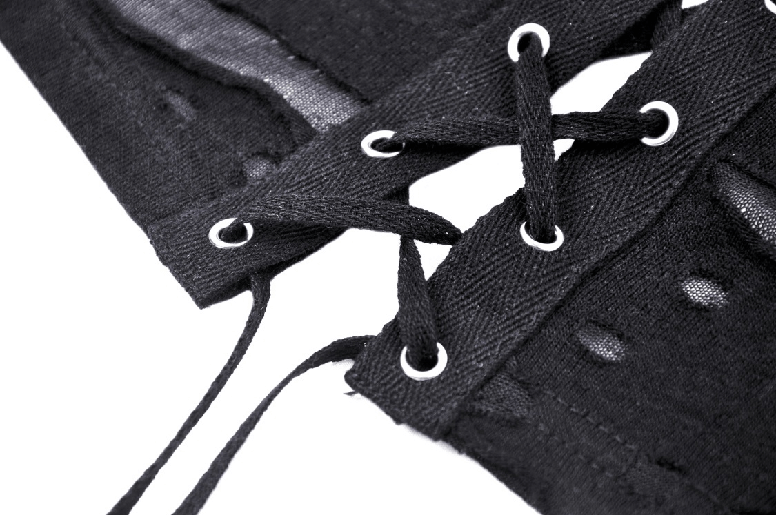 Close-up of black lace-up detailing on edgy crop top, showcasing unique design elements and stylish craftsmanship.