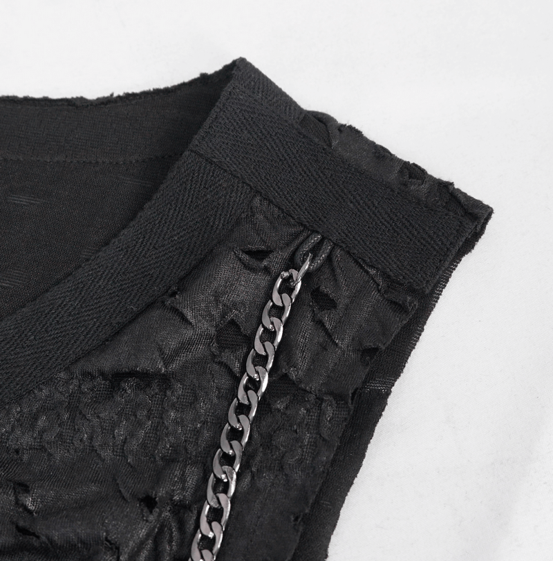 Detail of men's punk rock sleeveless black top showcasing broken holes and decorative chain.