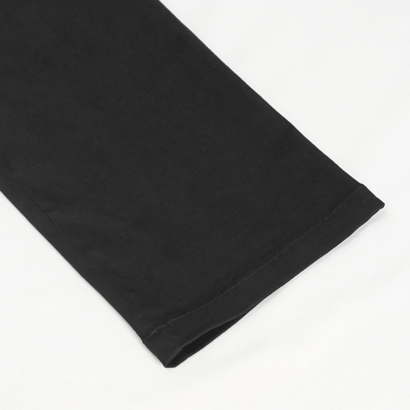 Close-up of the hem of men's black punk rock fitted pants, showcasing sleek fabric and stylish design.
