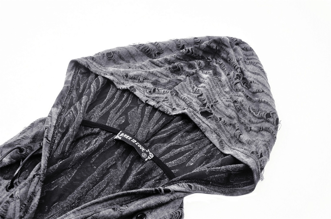 Close-up of a punk rock off-shoulder hoodie with a ripped neckline and asymmetrical cutout design.