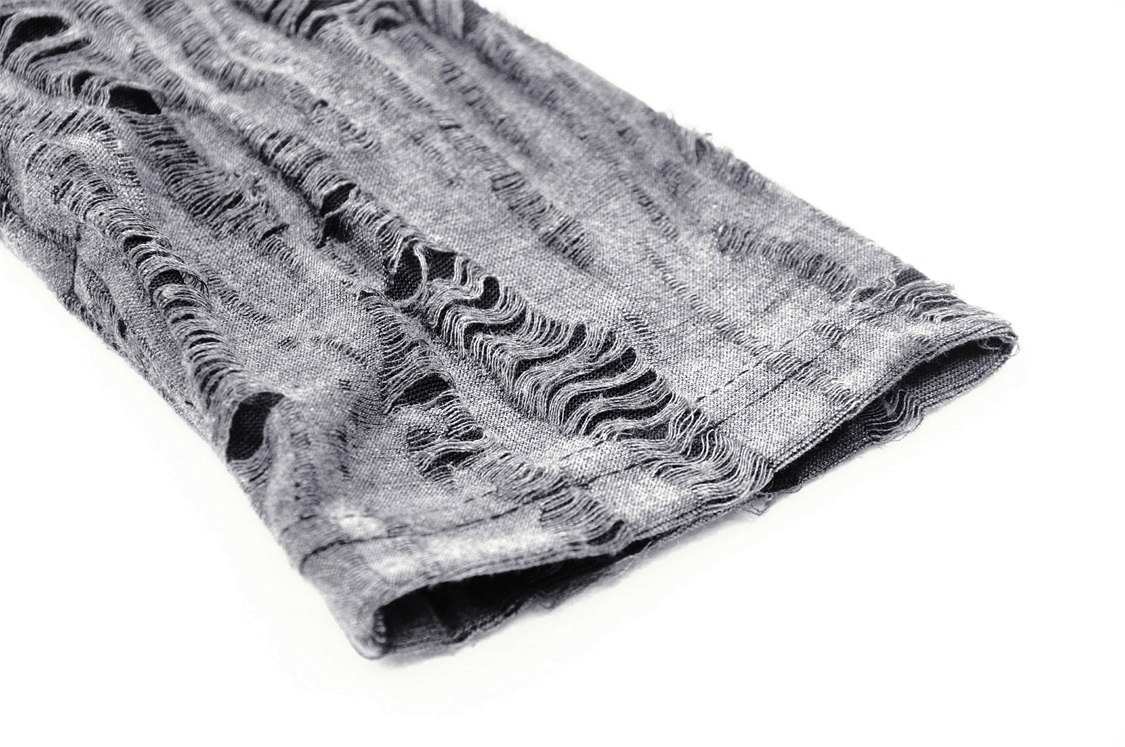 Close-up of a ripped, asymmetrical cut fabric showcasing punk rock style for edgy fashion enthusiasts.