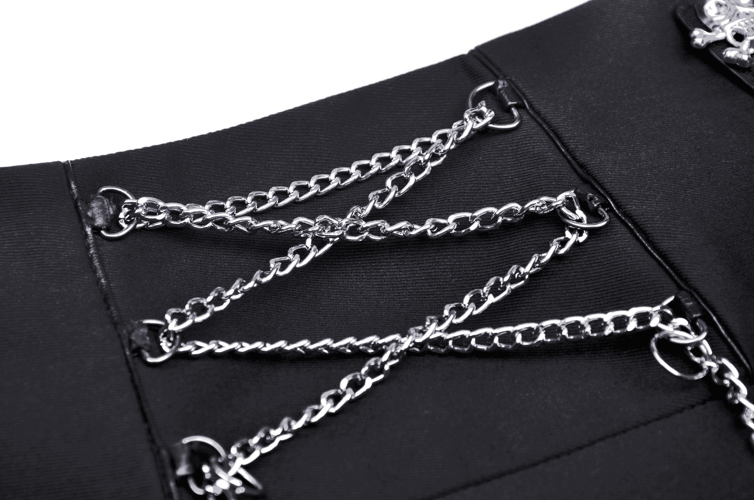Close-up of black mini skirt chain lace-up detailing, showcasing edgy punk rock style with silver chains.