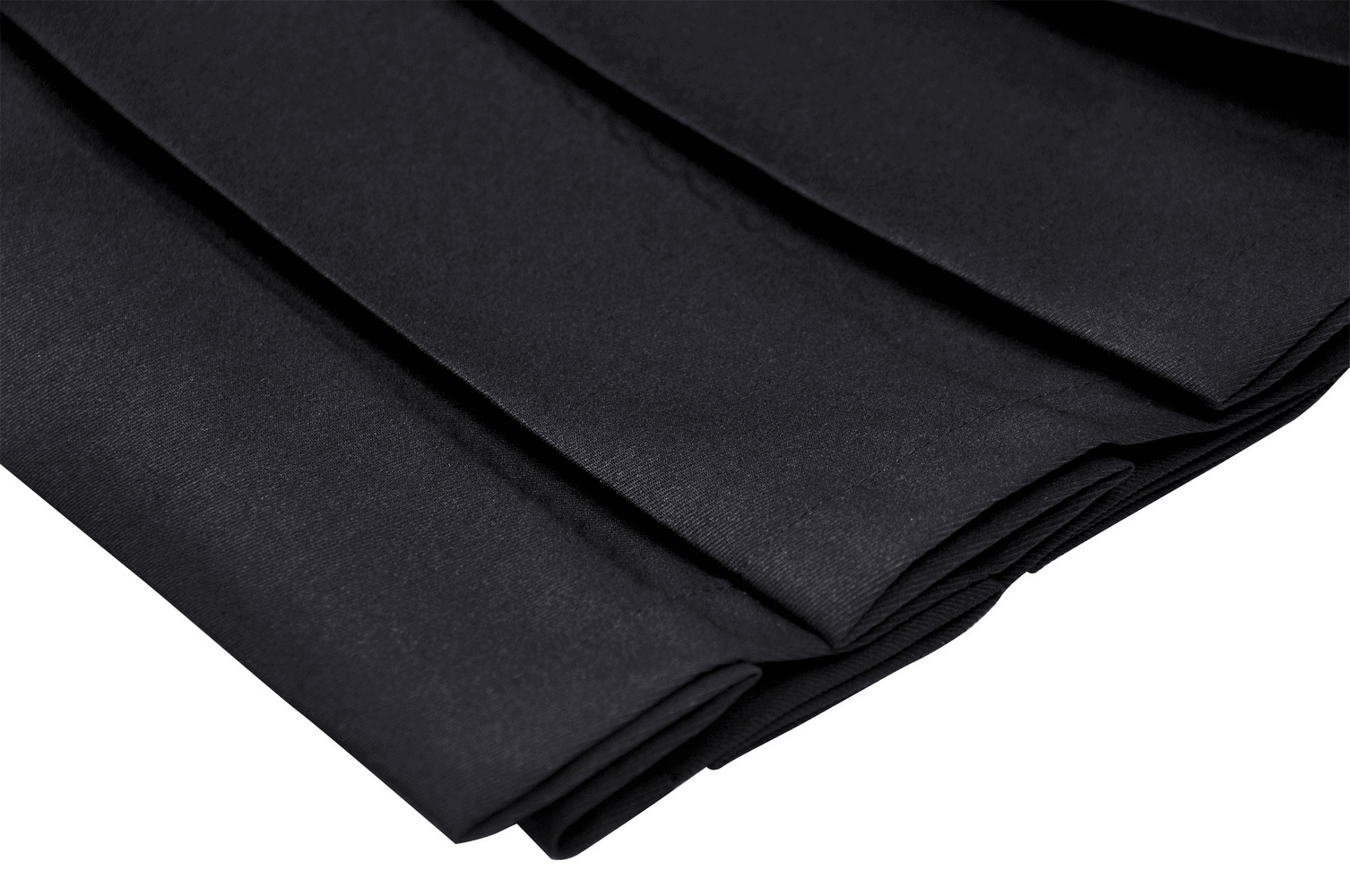 Close-up of black pleated fabric showcasing sharp pleats of a punk rock mini skirt.