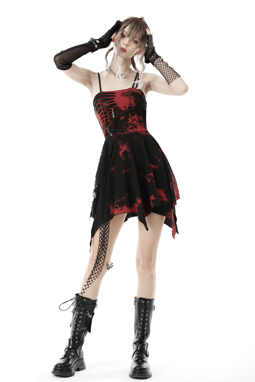 Model wearing a punk rock red and black asymmetrical dress with mesh overlay and combat boots.