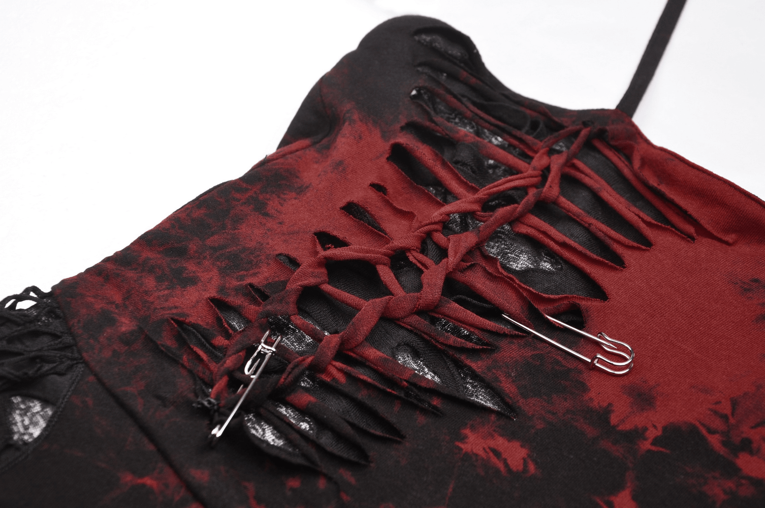 Close-up of punk rock red and black asymmetrical dress showcasing mesh overlay and corset lacing details.