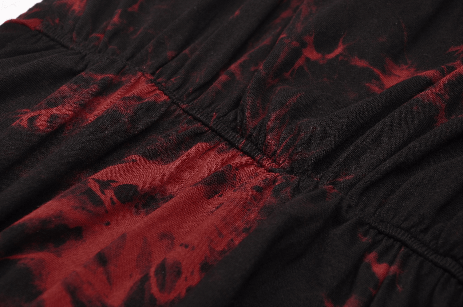 Close-up of punk rock red and black fabric with a striking mesh overlay design for gothic elegance.