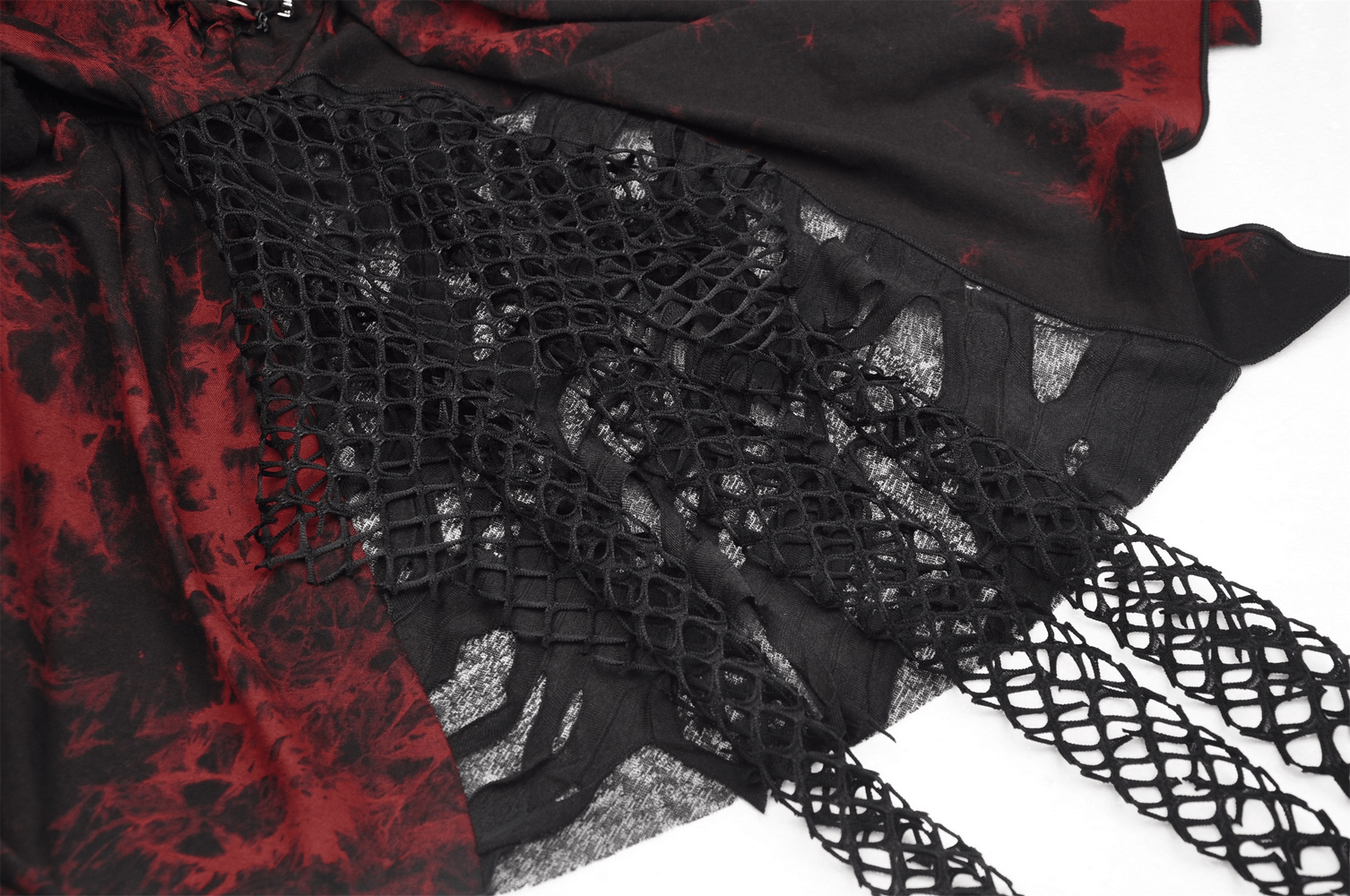 Close-up of a punk rock red and black asymmetrical dress with mesh overlay and intricate cut-out detailing.