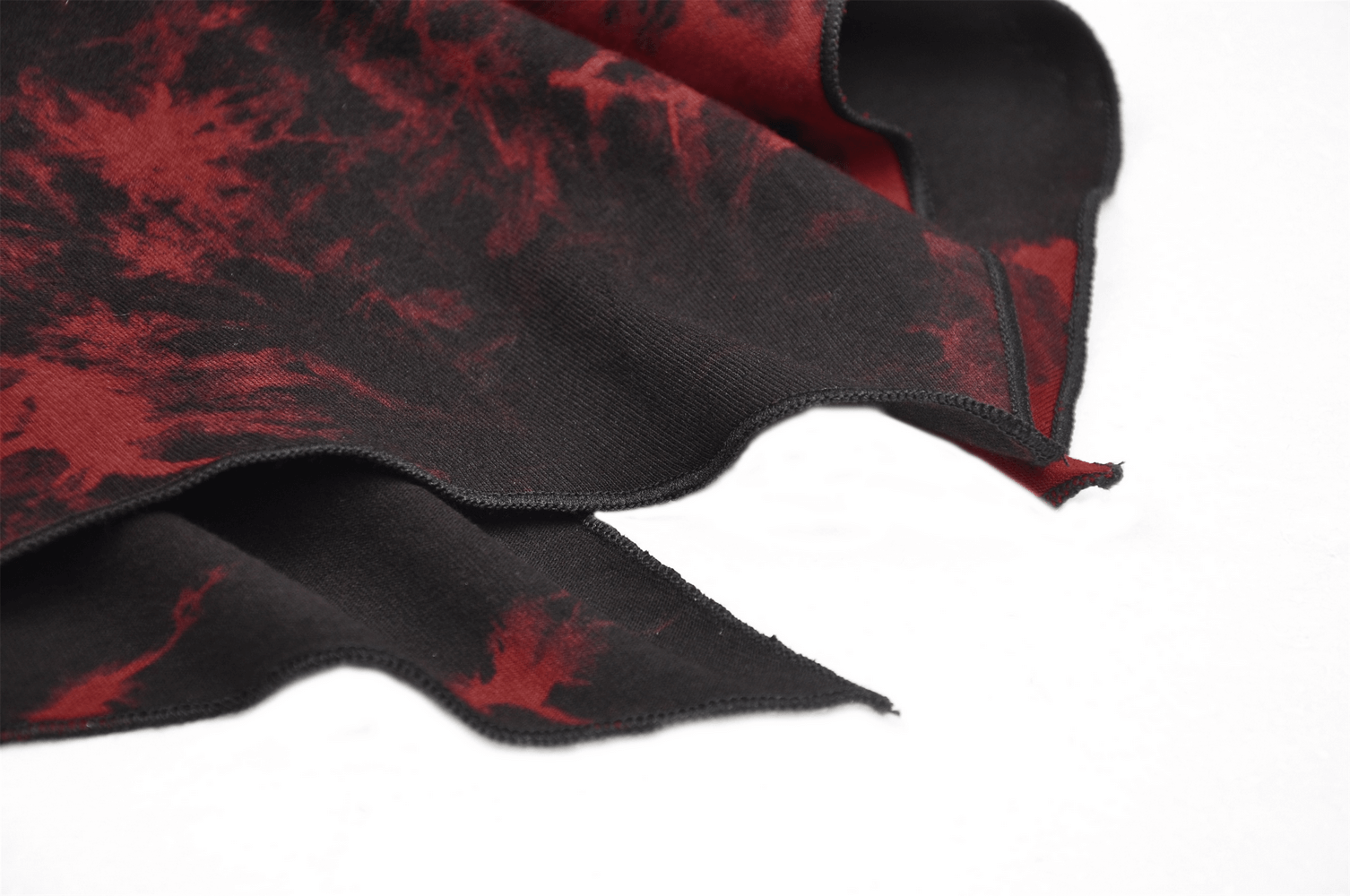 Close-up of red and black tie-dye fabric perfect for a punk rock dress or gothic fashion.