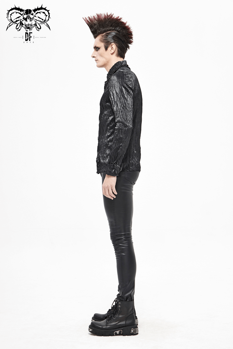 Stylish male model in punk rock black long-sleeved shirt with edgy hairstyle and fitted pants.