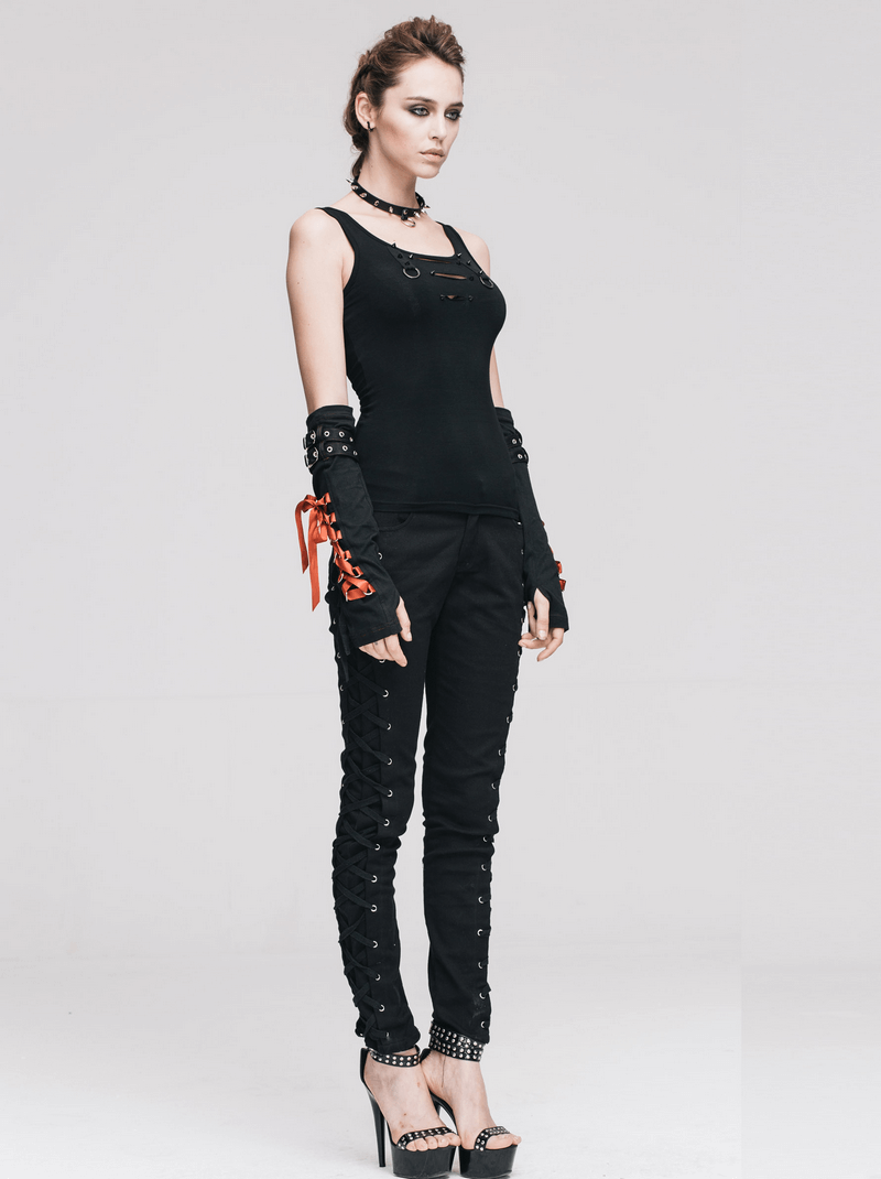 Stylish model wearing punk rock black skinny pants with lace-up sides and matching top, showcasing edgy fashion.