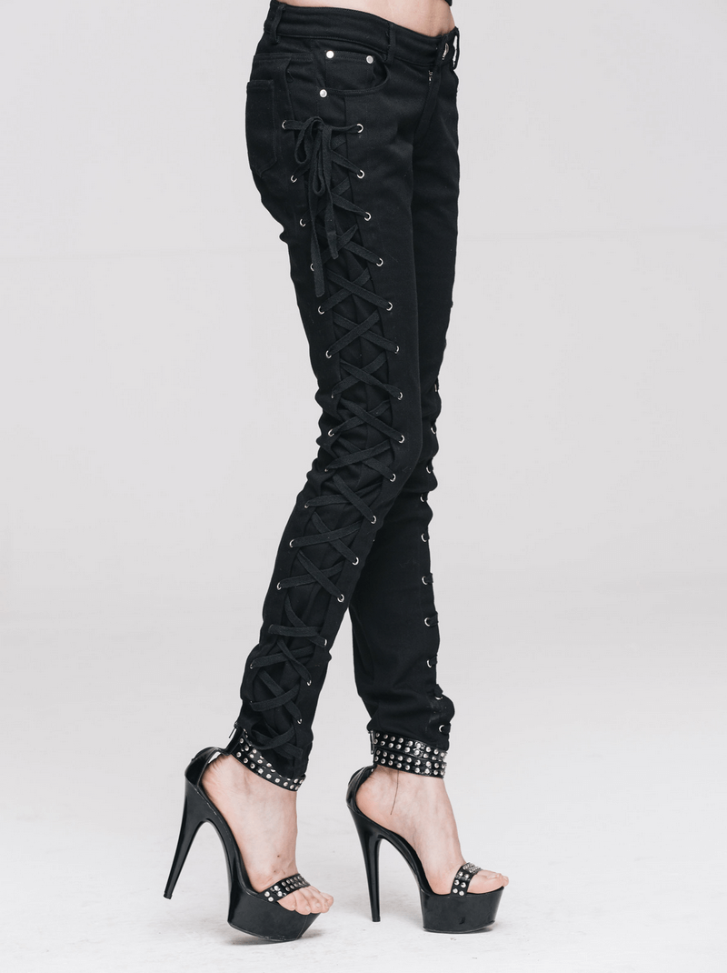 Punk rock women's black skinny pants with lace-up sides, paired with stylish high heels for a bold look.