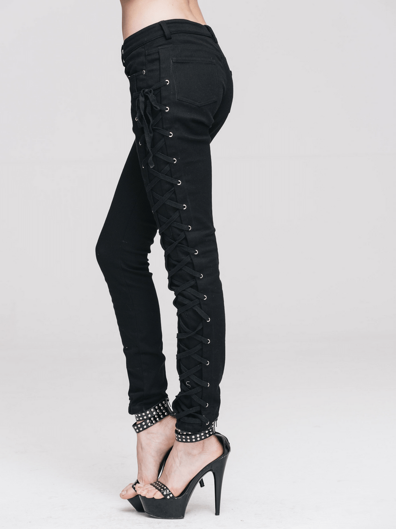 Punk rock women's black skinny pants with lace-up sides, showcasing stylish design and a form-fitting cut.