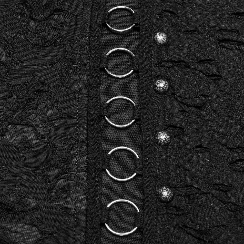 Close-up of punk pants with iron ring detailing and snap buttons on tattered fabric.