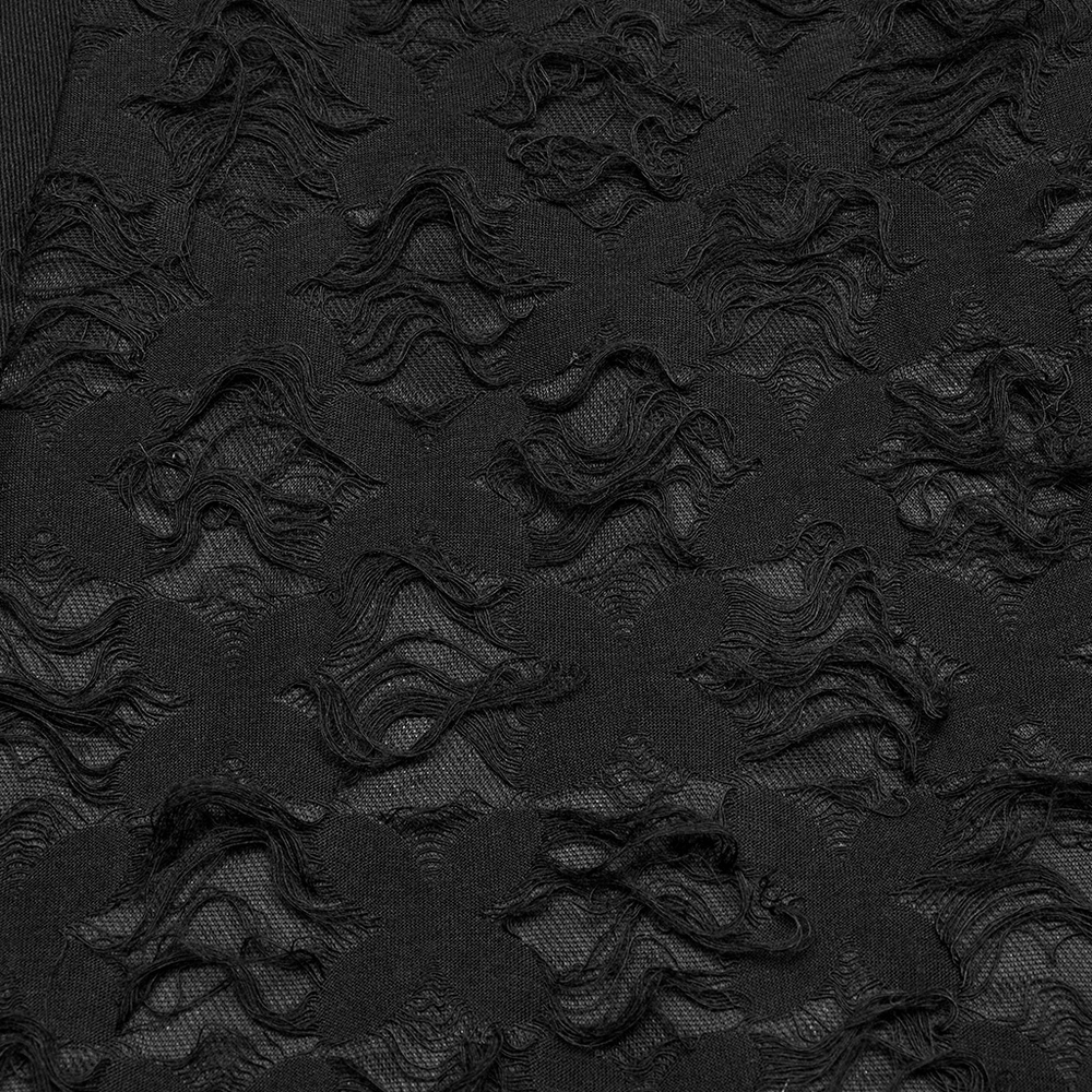 Close-up of textured black fabric with wave-like patterns, showcasing the unique design of punk-style pants.