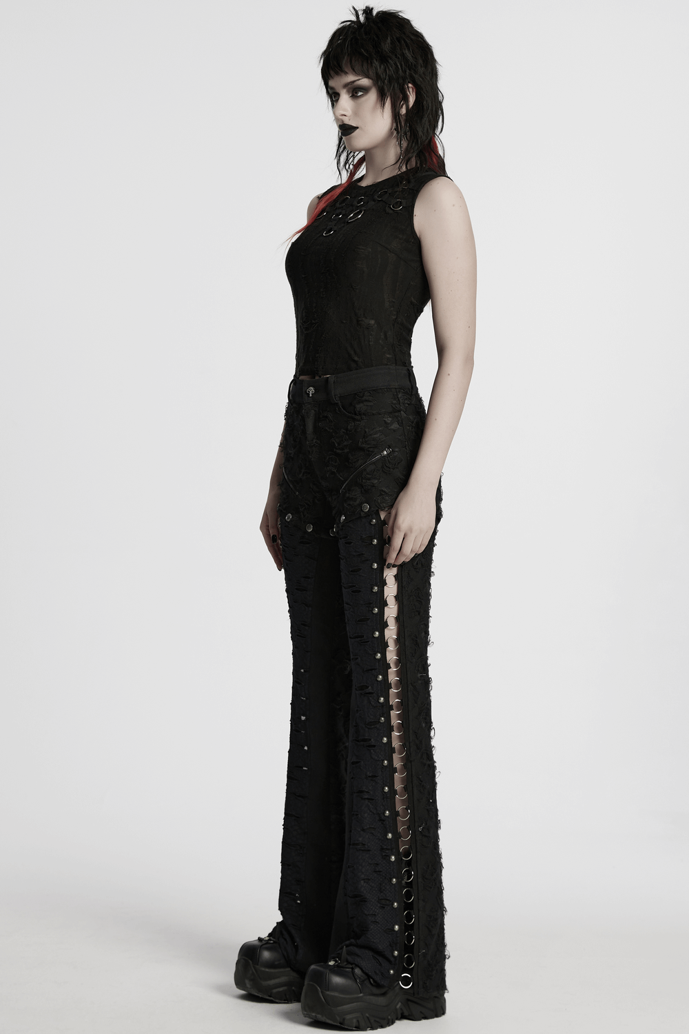 Model showcasing punk rose-embellished split wide leg tattered pants with iron ring detailing.