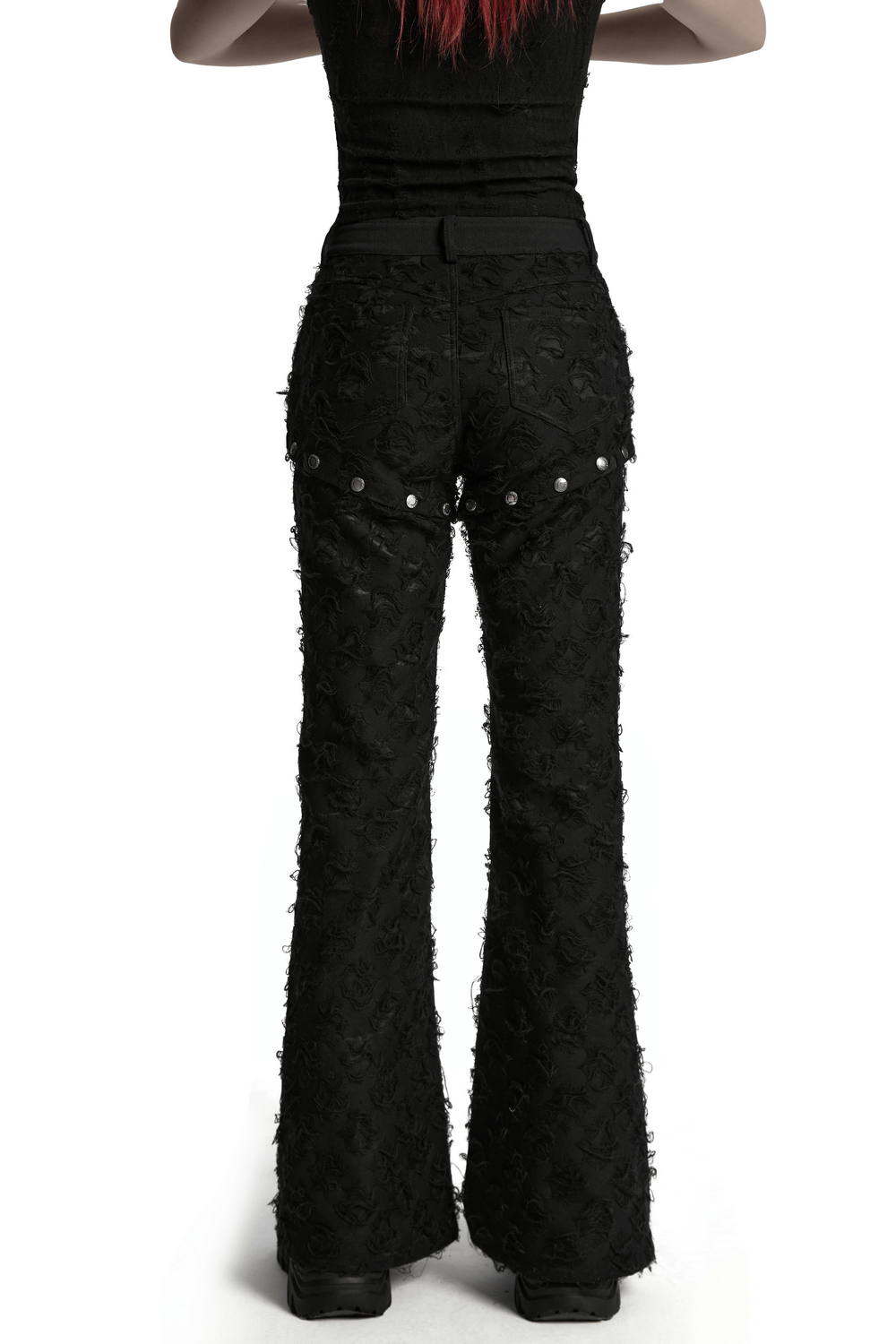 Back view of punk rose-embellished split wide leg tattered pants with detachable snap button details.