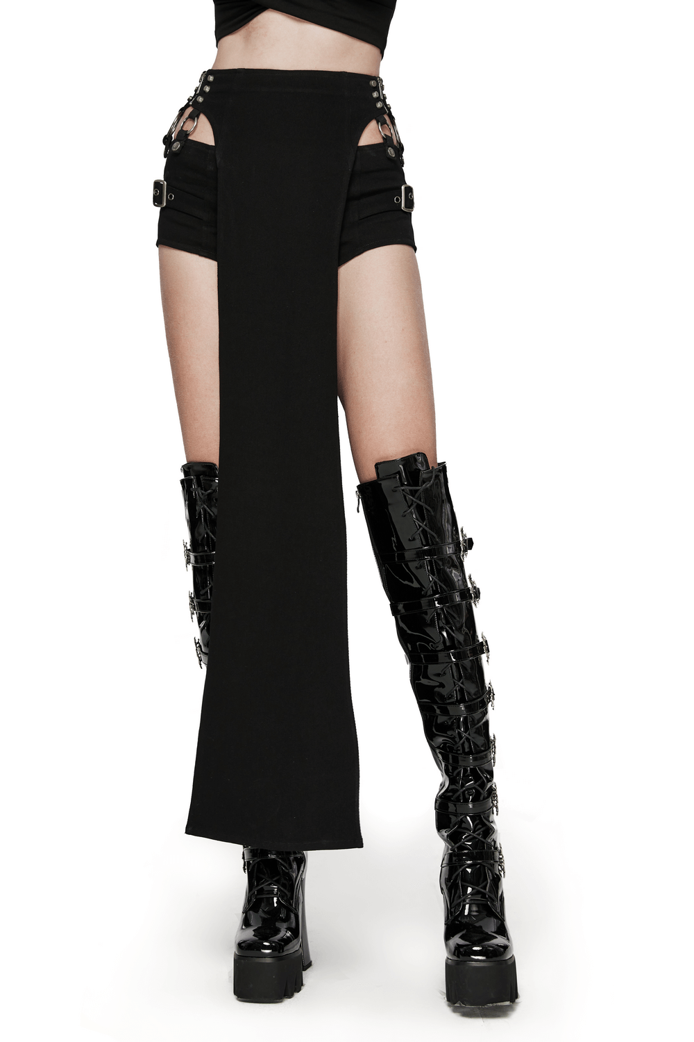Punk-inspired sexy black shorts and long skirt set with side cutouts and metal hoops, styled with shiny black boots.