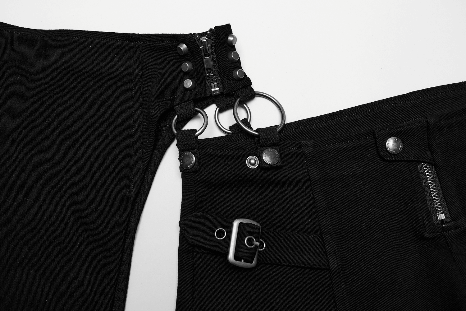 Edgy black shorts with punk-inspired side cutouts, metal hoops, and rivets for a stylish rockstar look.