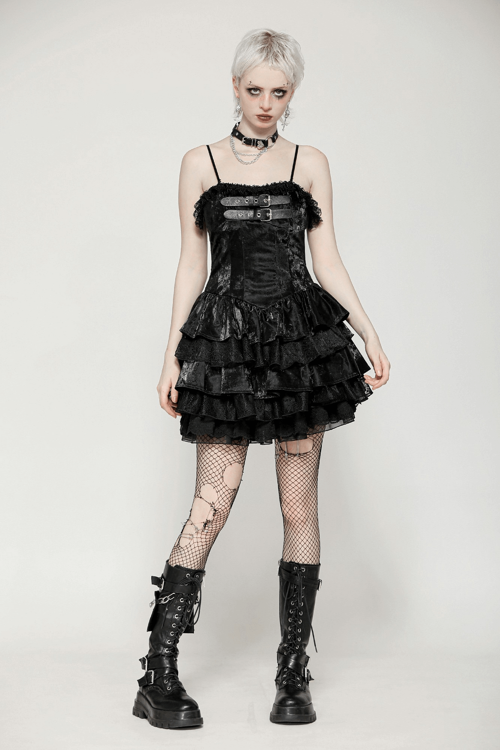 Punk shiny PU leather layered dress with ruffled lace, black fishnet stockings, and combat boots for gothic fashion lovers.