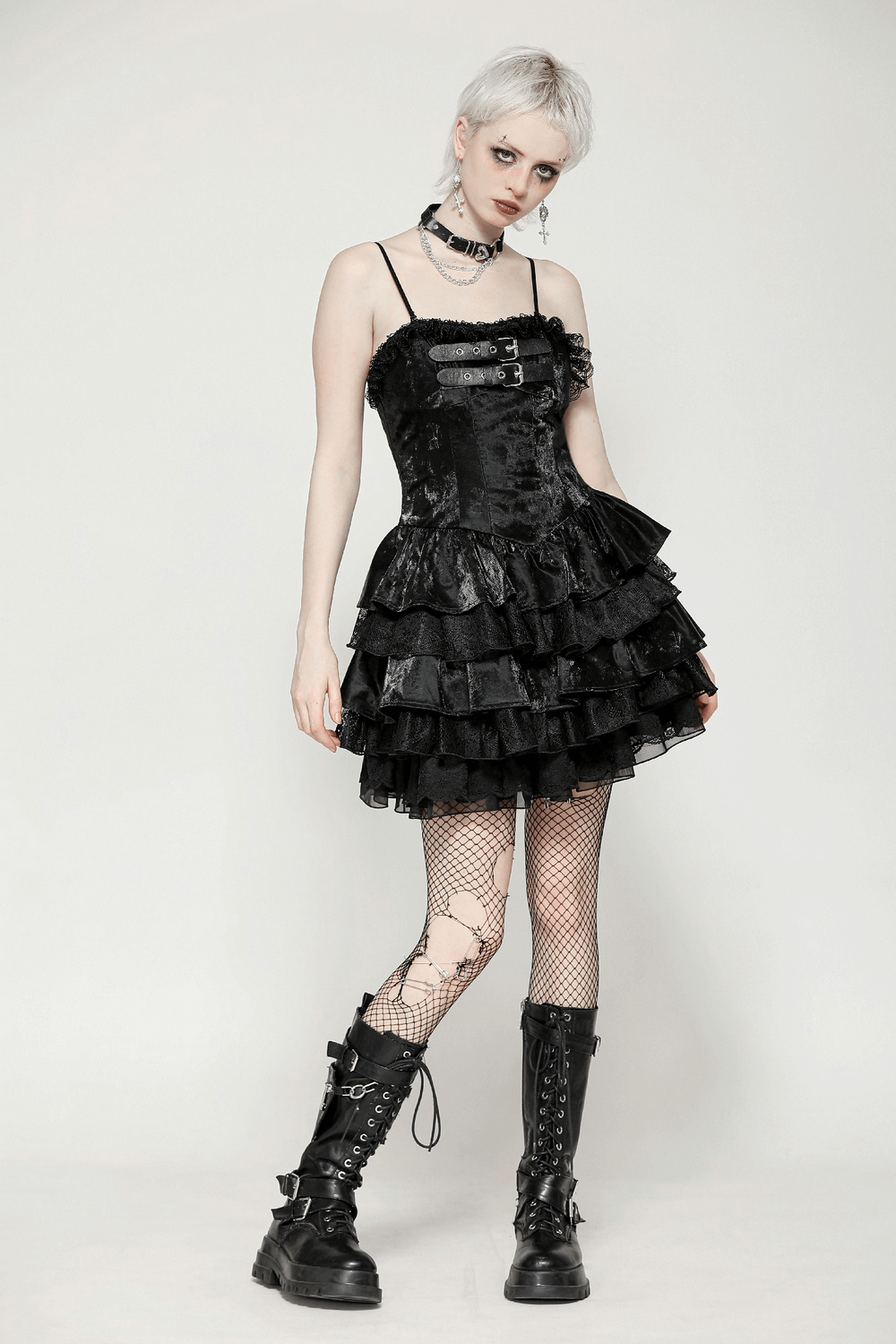 Gothic black mini dress with layered ruffles, adjustable straps, and punk accessories for alternative fashion lovers.