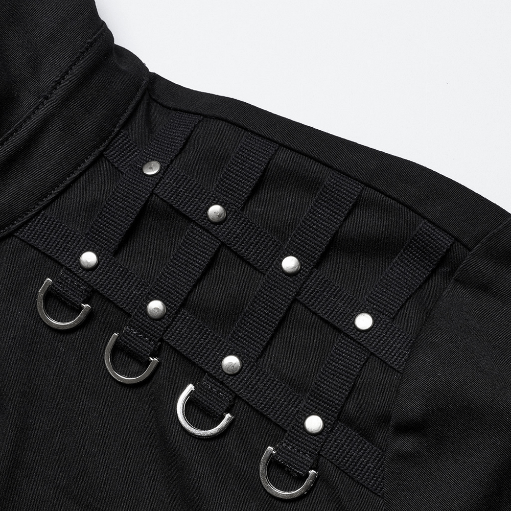 Close-up of studded shoulder details and woven webbings on a black punk shirt, showcasing unique gothic style.