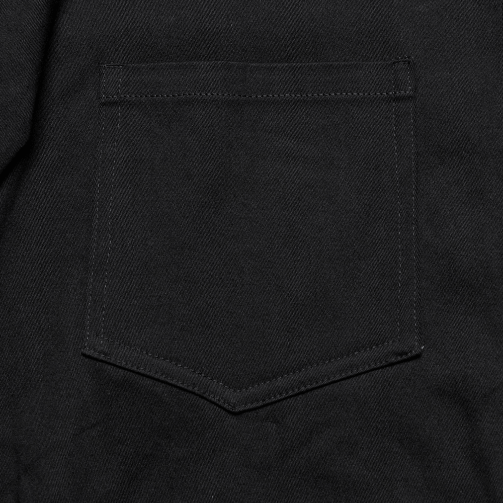 Close-up of the black twill shirt's pocket, showcasing stylish stitching and a sleek design element.