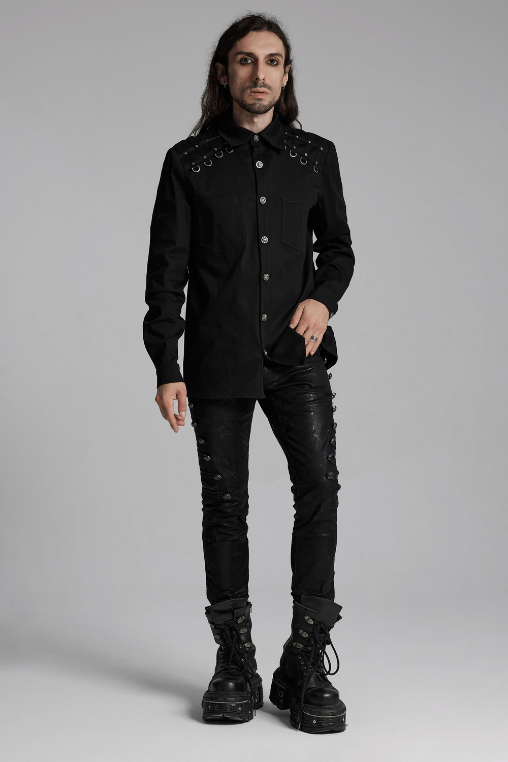 Stylish men's black punk shirt with studded shoulder details, paired with distressed pants and chunky boots. Perfect for alternative fashion.