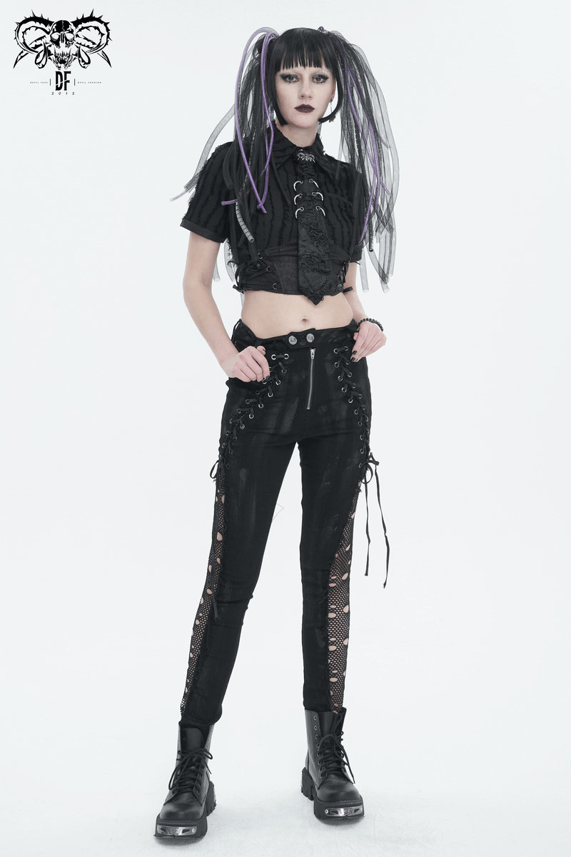 Gothic punk fashion model in stylish black outfit with lace-up details and striking hair, embodying edgy alternative style.