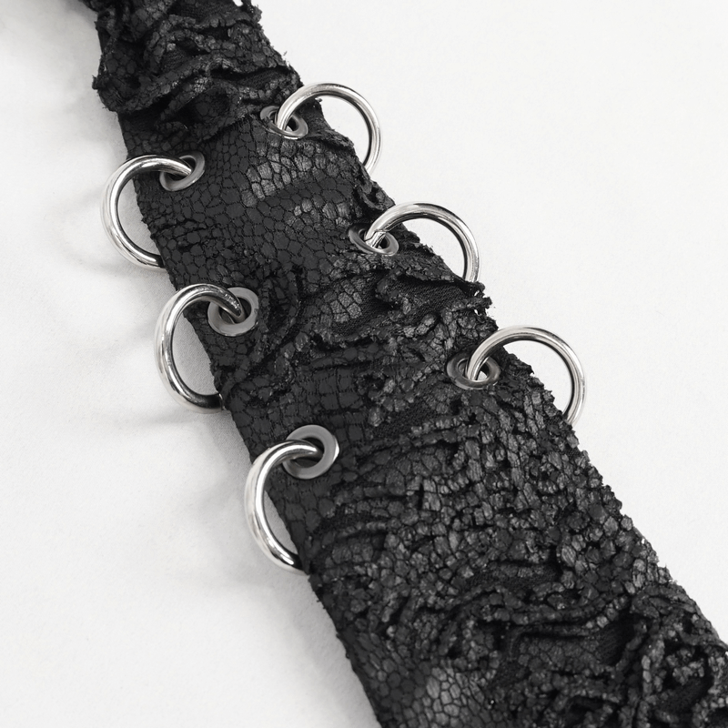 Close-up of a black punk necktie showcasing metal rings and intricate texture for a gothic style.