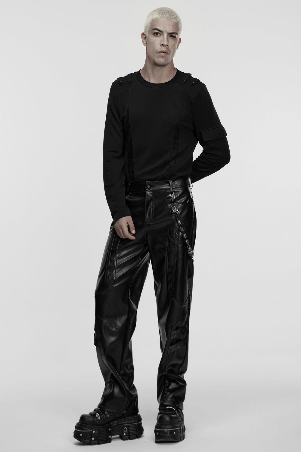 Model wearing black punk style pants and long sleeve top, showcasing edgy street style with metal accents.