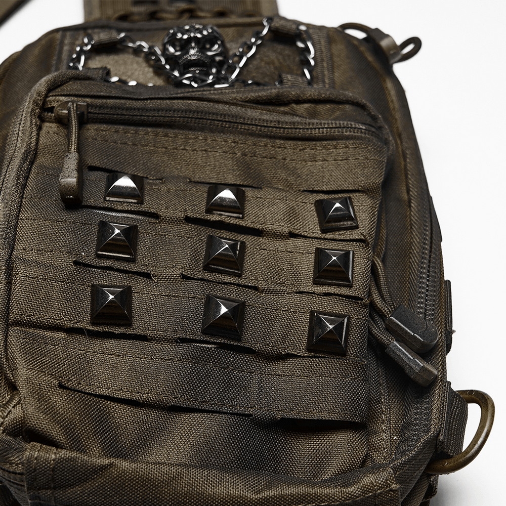 Close-up of Punk Skull Stud Crossbody Backpack with Strap showing black pyramid studs and metal skull detail.