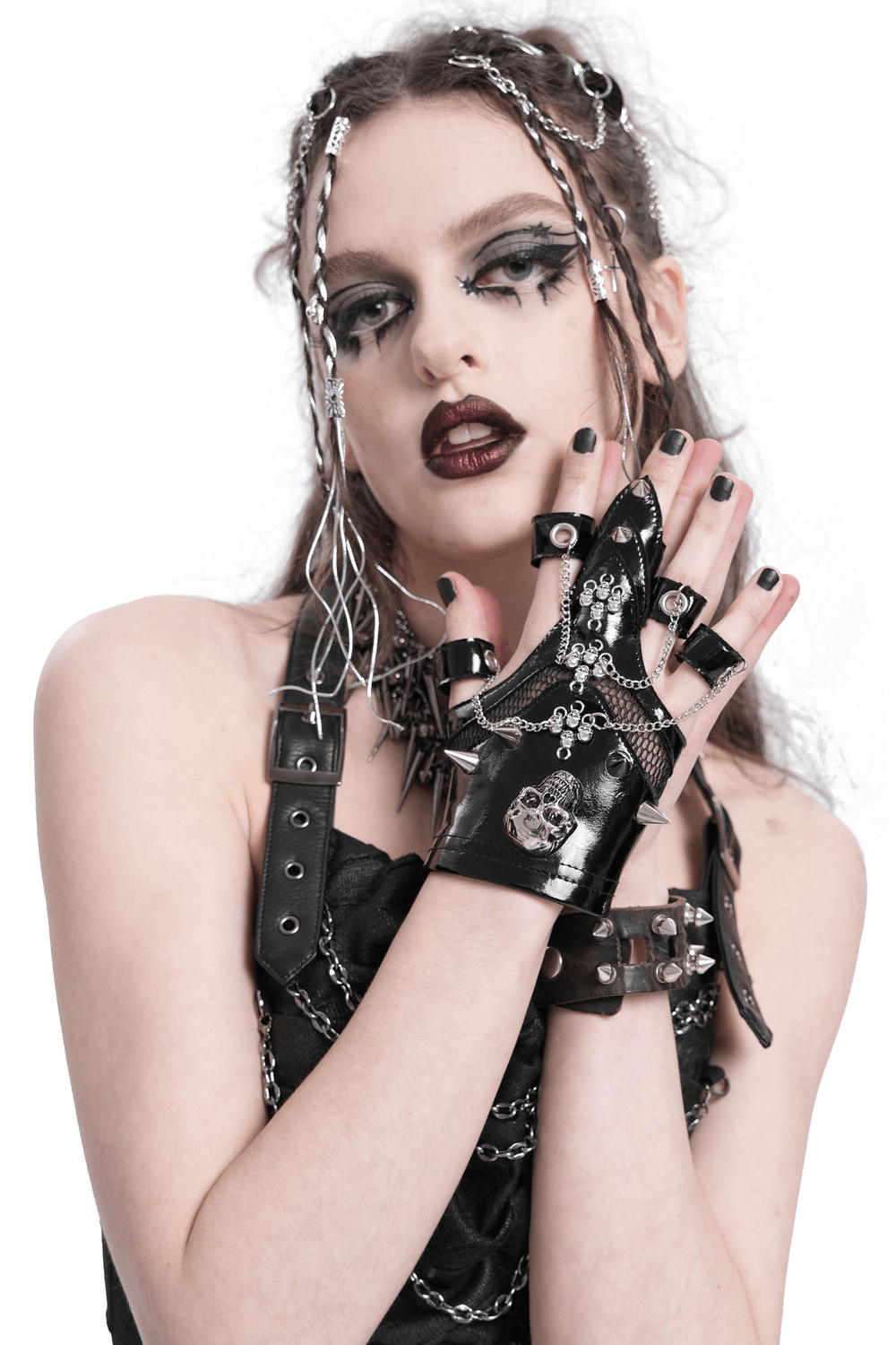 Punk skull studded fingerless gloves with chains on model, showcasing gothic style and edgy fashion.