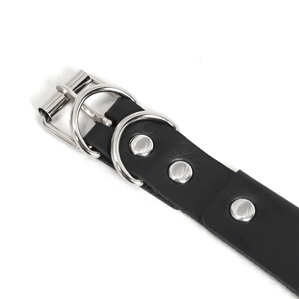 Close-up of a punk spiked belt choker featuring silver rivets and a stylish buckle.