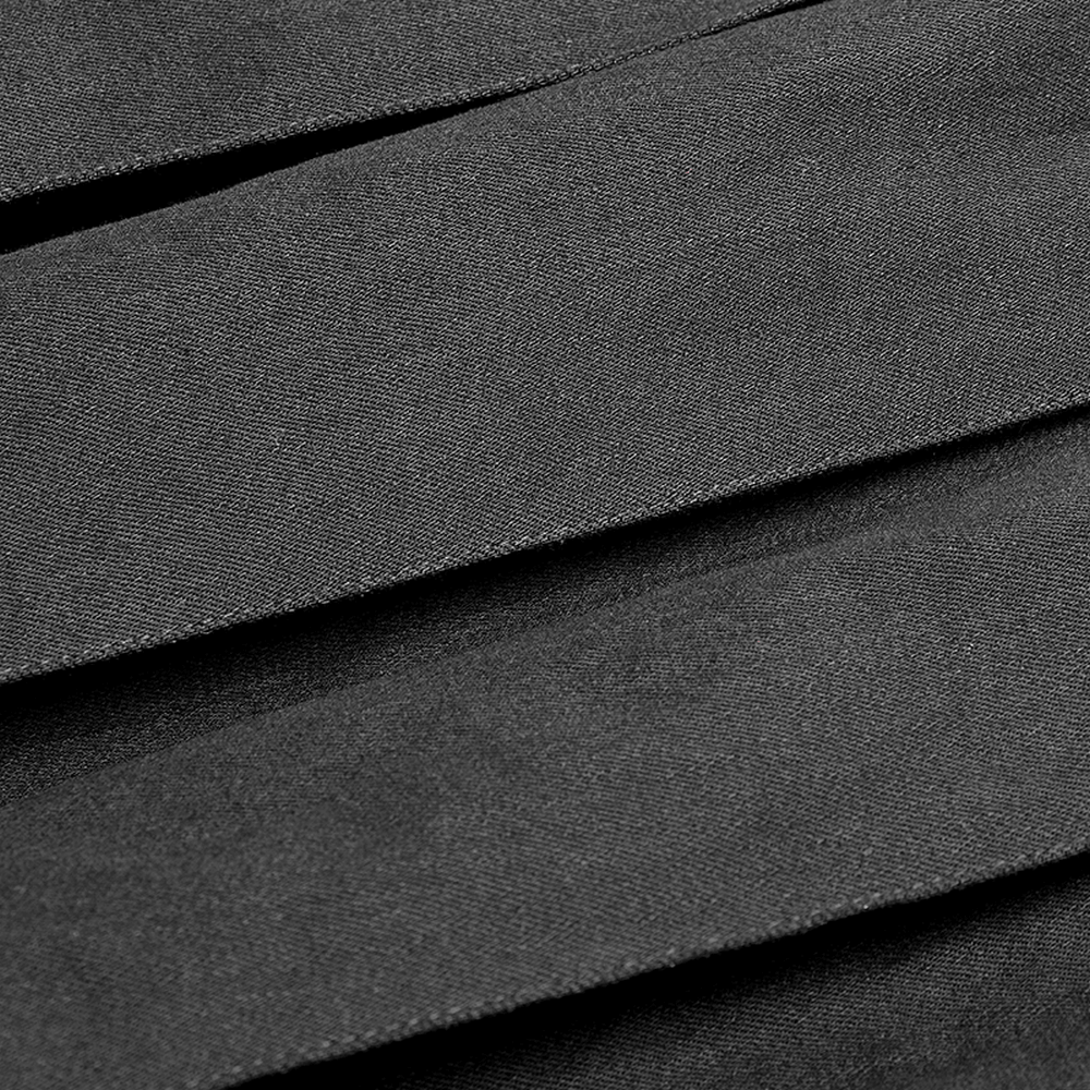 Close-up of spliced black faux leather fabric showcasing texture and layers for a punk half kilt skirt.