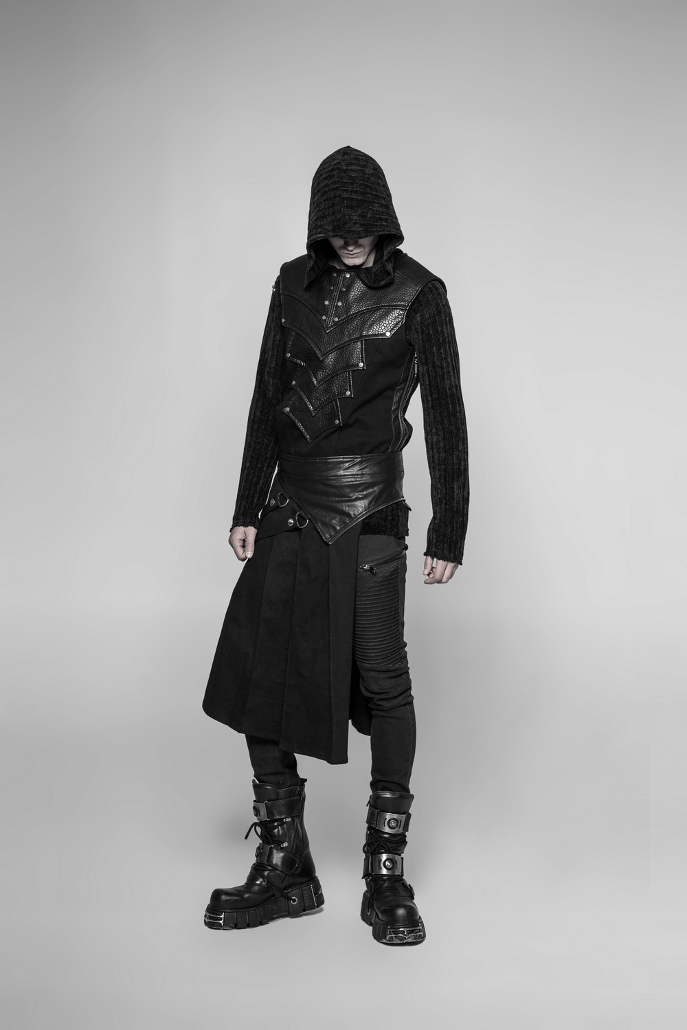 Edgy model in black punk outfit with detachable half kilt skirt, showcasing bold style and unique rebel flair.