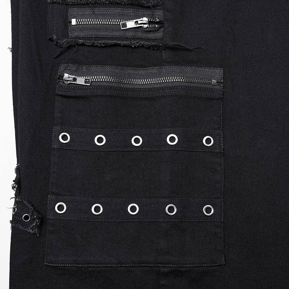Close-up of punk denim pants featuring metal zippers and cross patch accents for a bold, edgy look.