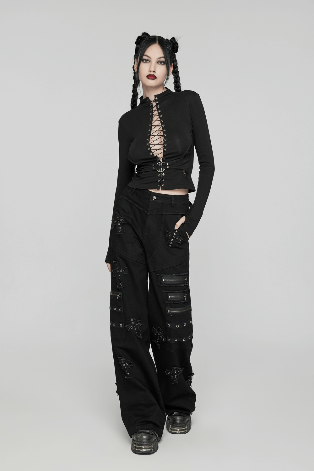 Gothic model wearing punk straight-leg denim pants with cross patches and zipper accents, showcasing edgy fashion.