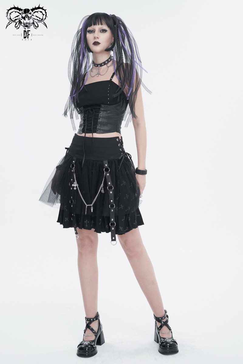 Punk gothic woman in black strappy top and layered skirt, showcasing edgy alternative fashion style.