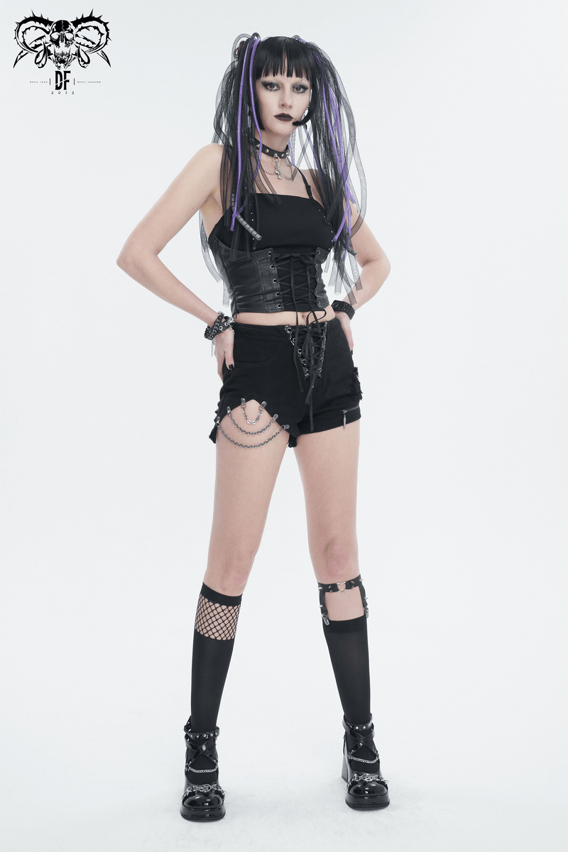 Stylish woman in gothic punk outfit featuring black camisole, shorts, and lace accessories, embodying punk fashion.