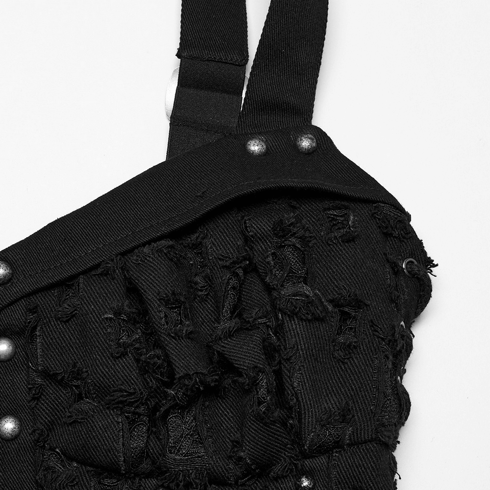 Close-up of punk studded denim top featuring adjustable drawstrings and distressed fabric detail.