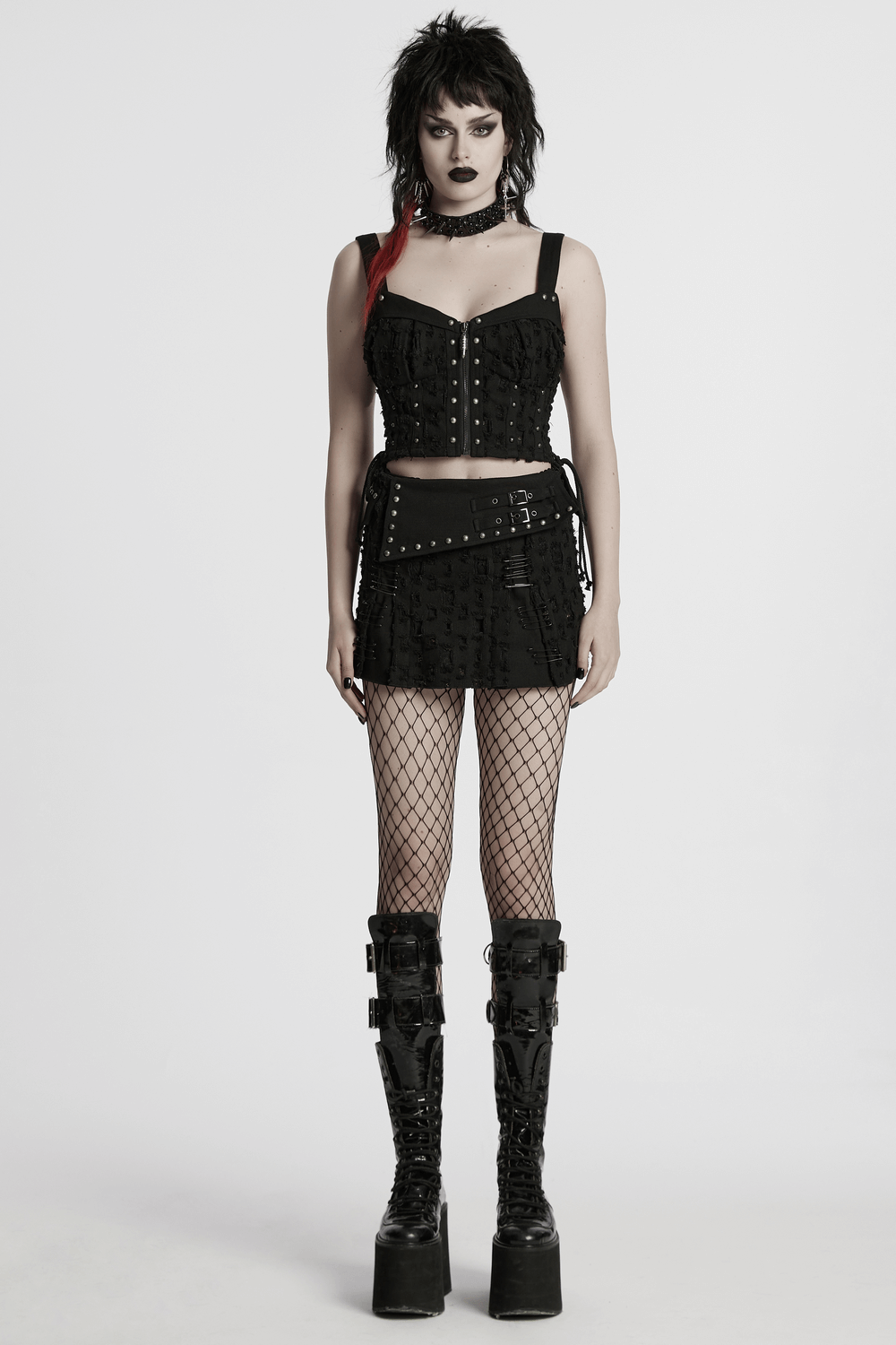 Punk studded denim top with adjustable drawstrings, paired with a fishnet skirt and edgy platform boots.