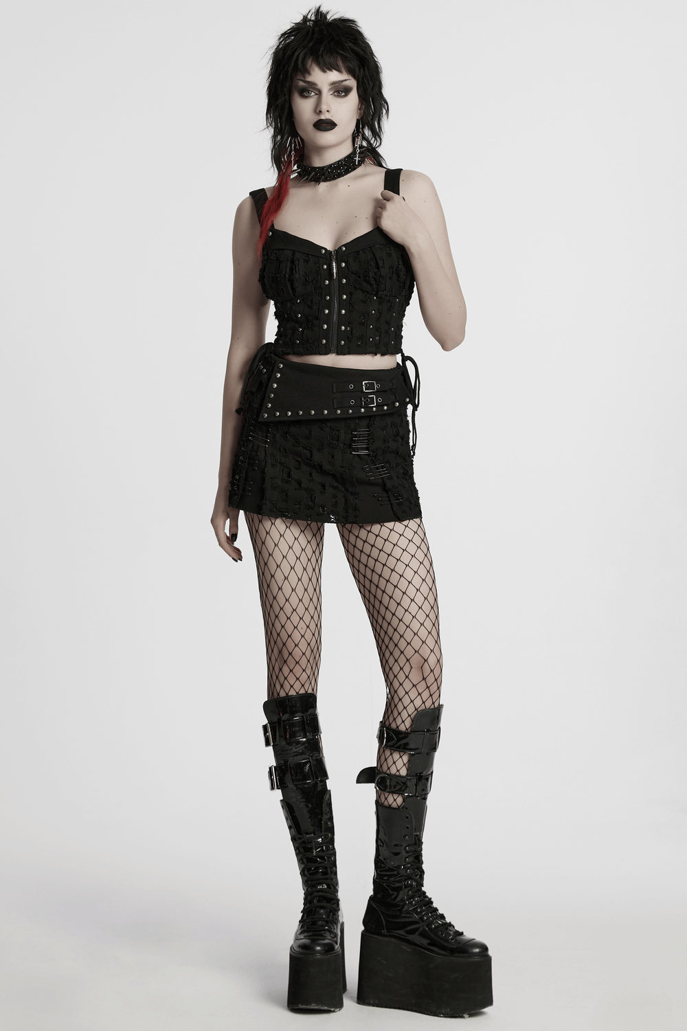 Punk studded denim top with adjustable drawstrings worn with a stylish mini skirt and chunky boots.